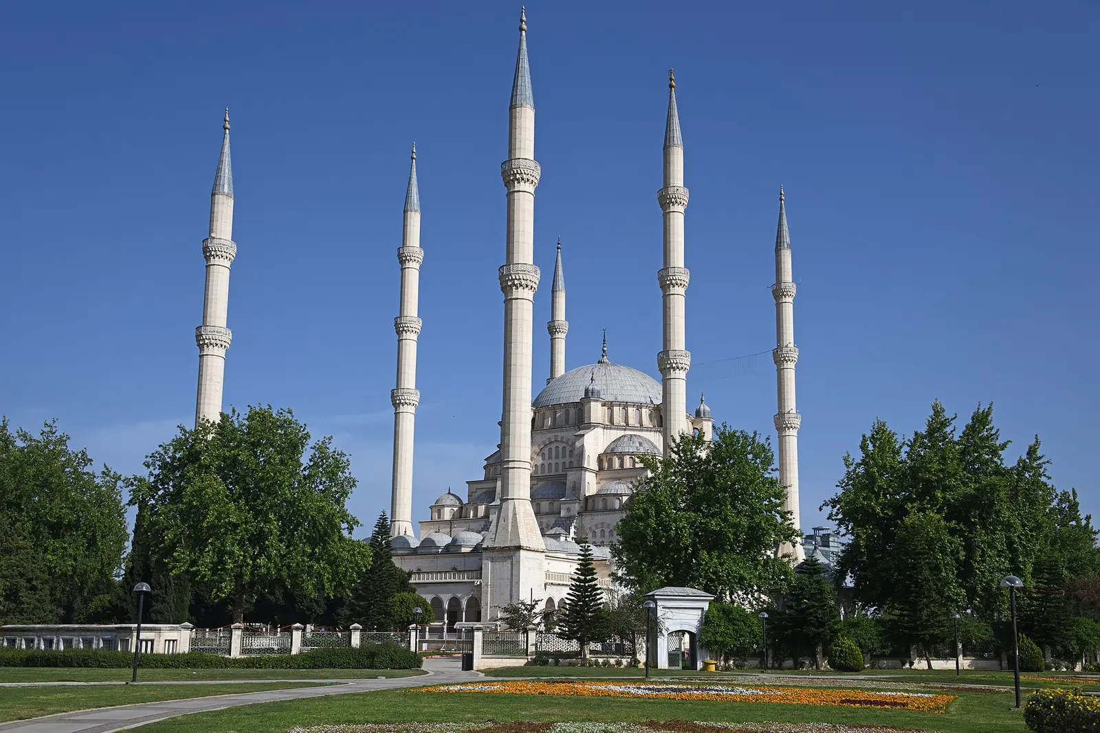 Sabanci Central Mosque with its six minarets rising above Central Park in Adana under a blue sky