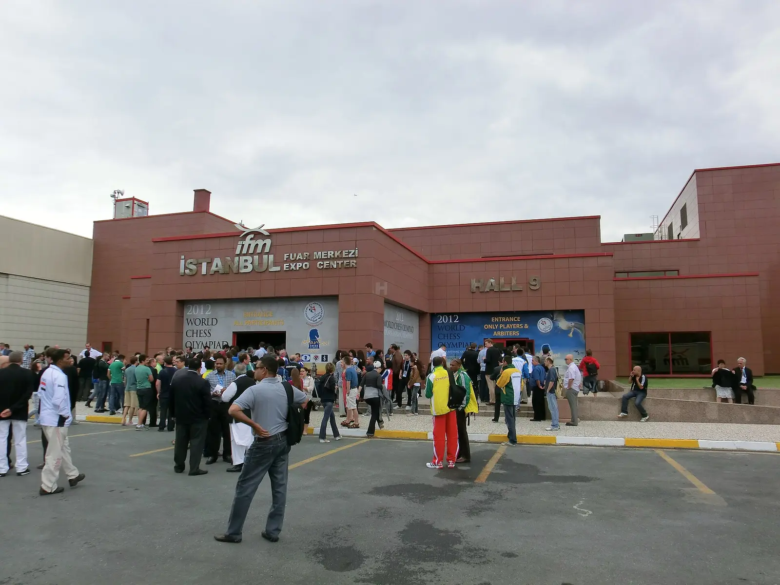 Brick entrance building of the Istanbul Expo Center with visitors gathered outside