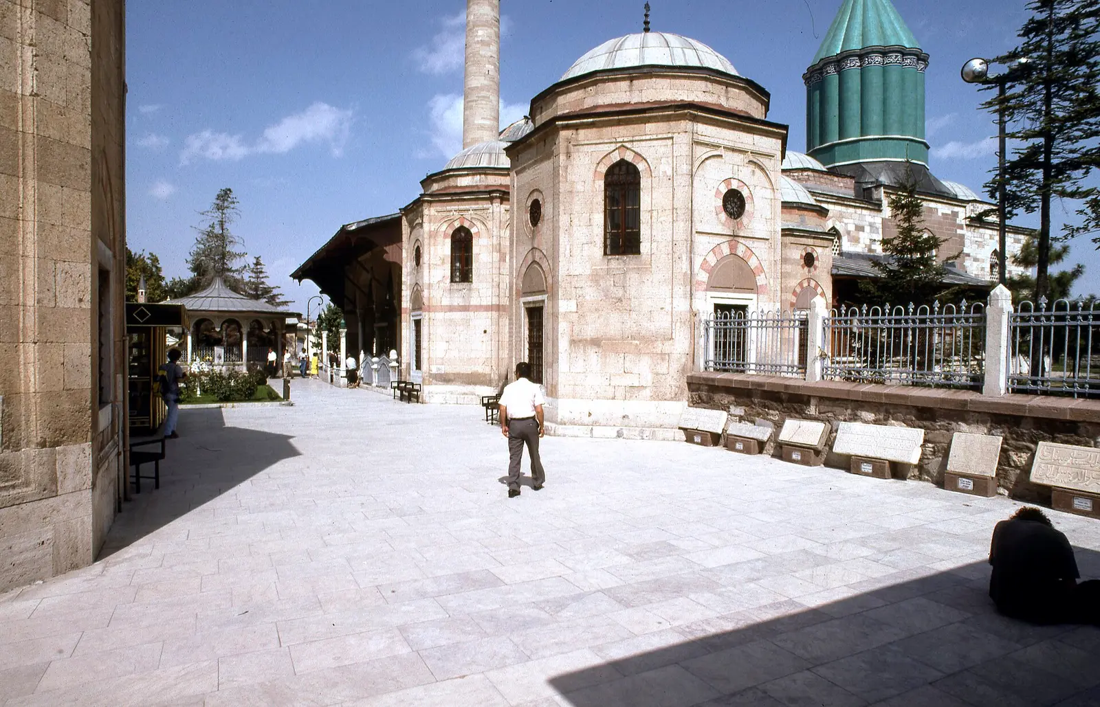 Courtyard of the Mevlana Museum in Konya with the green tiled dome of the mausoleum